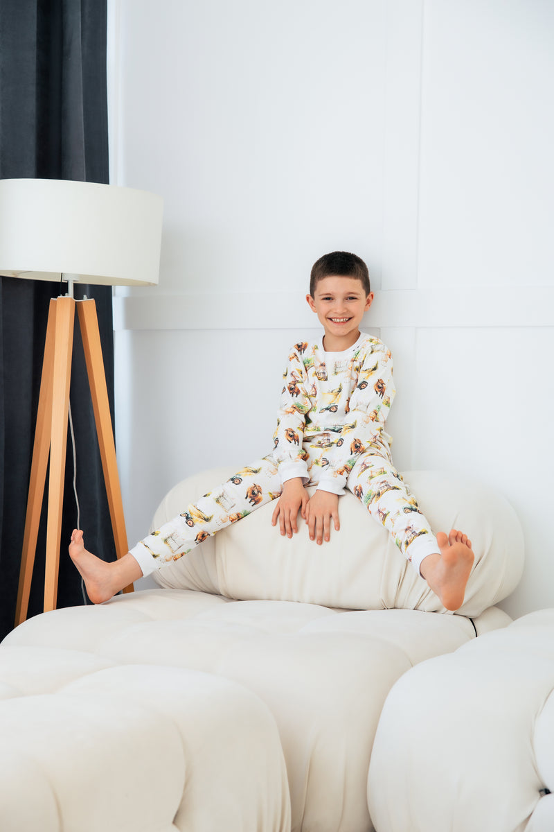 Kids farm pyjamas featuring adorable Highland cows and tractors – cosy and breathable cotton sleep set.