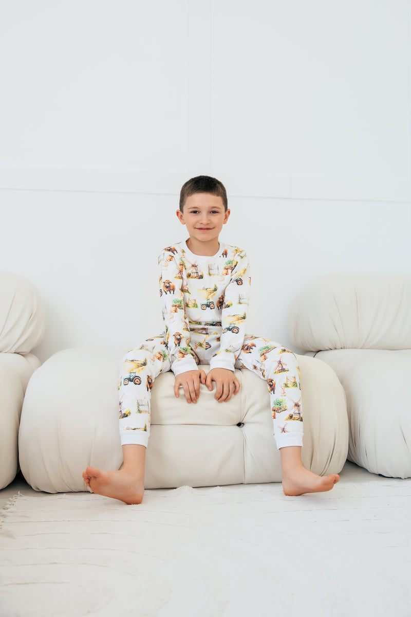Cosy pyjamas for children with farm animals and tractors – Highland cow print inspired by the Scottish countryside.